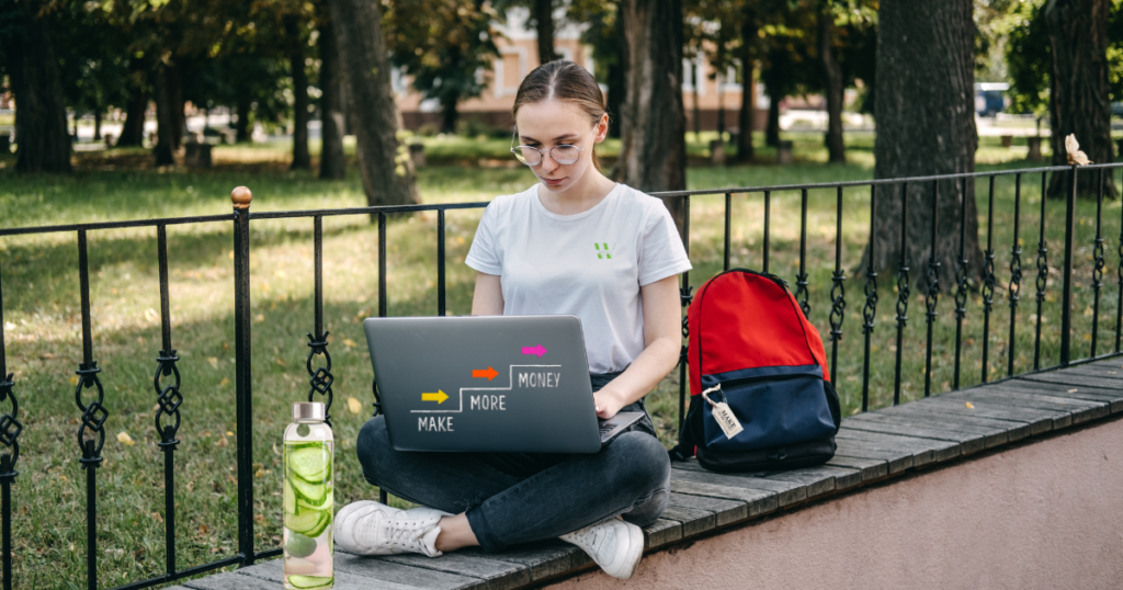 female student freelancer with laptop and backpack.